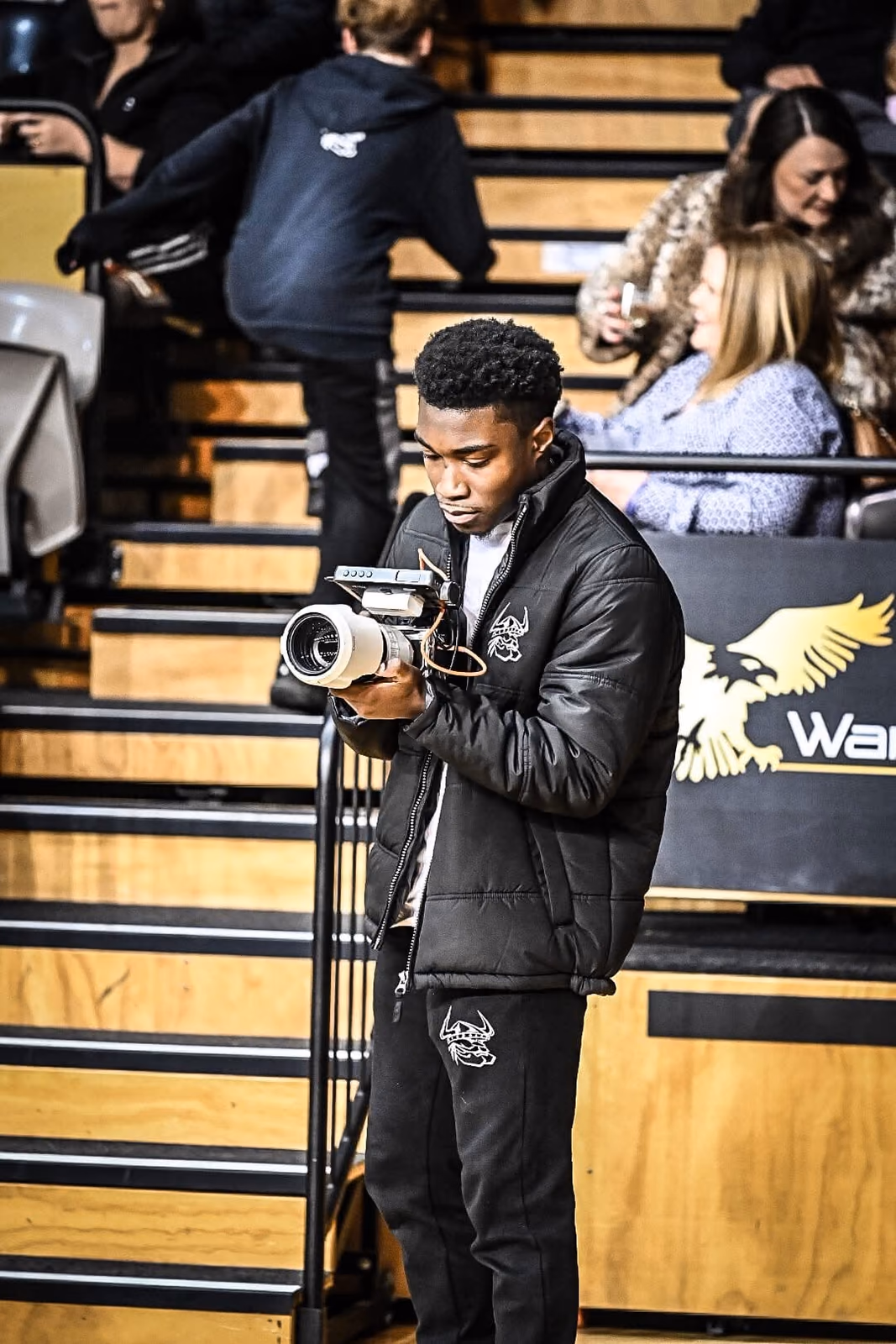 Olu with his camera in the arena stands