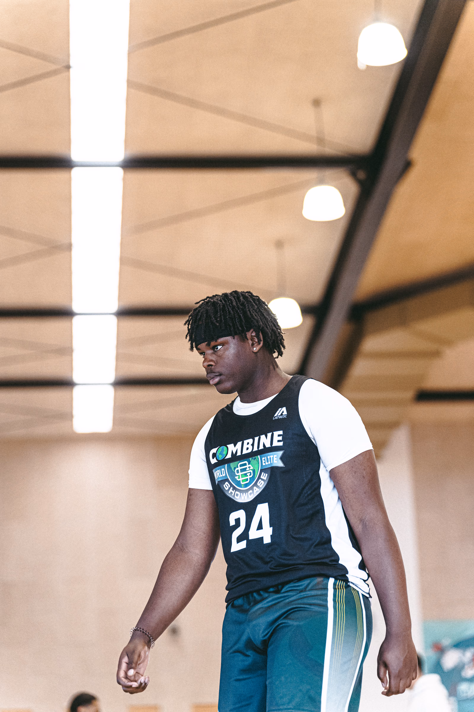 Young basketball prospect walking across a gym floor